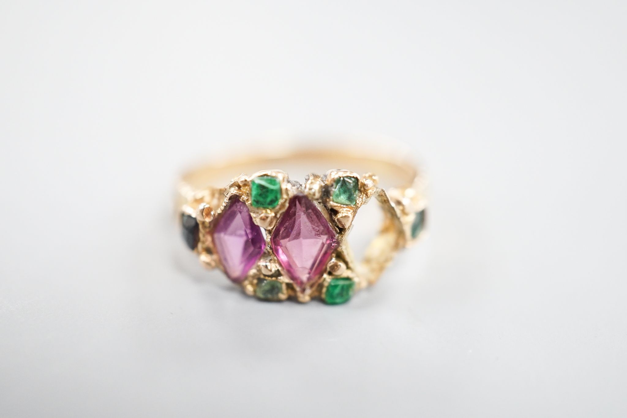 A late Victorian 15ct gold, garnet and emerald set dress ring(stone missing & stone replacement?), size L, gross 2.2grams.